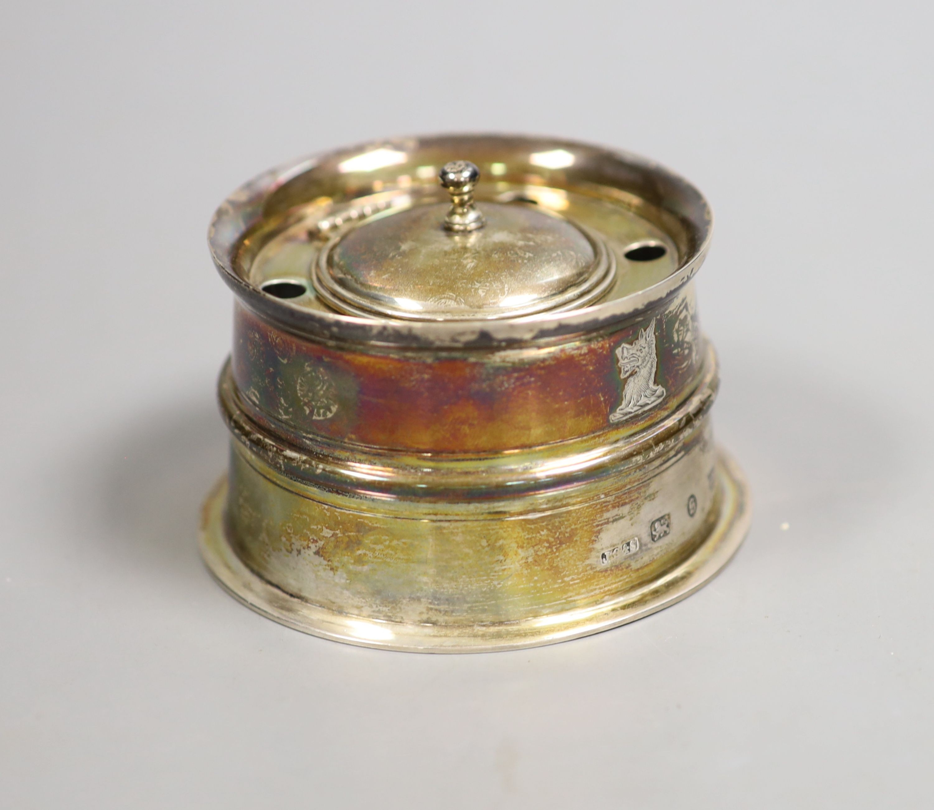 A late Victorian silver mounted glass circular desk inkwell, with domed cover and five pen holes, John Grinsell & Sons, Birmingham, 1892, height 52mm.